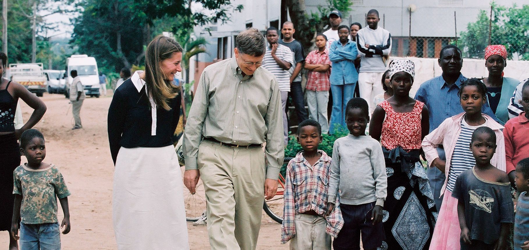 bill and melinda gates walk with children in third world country