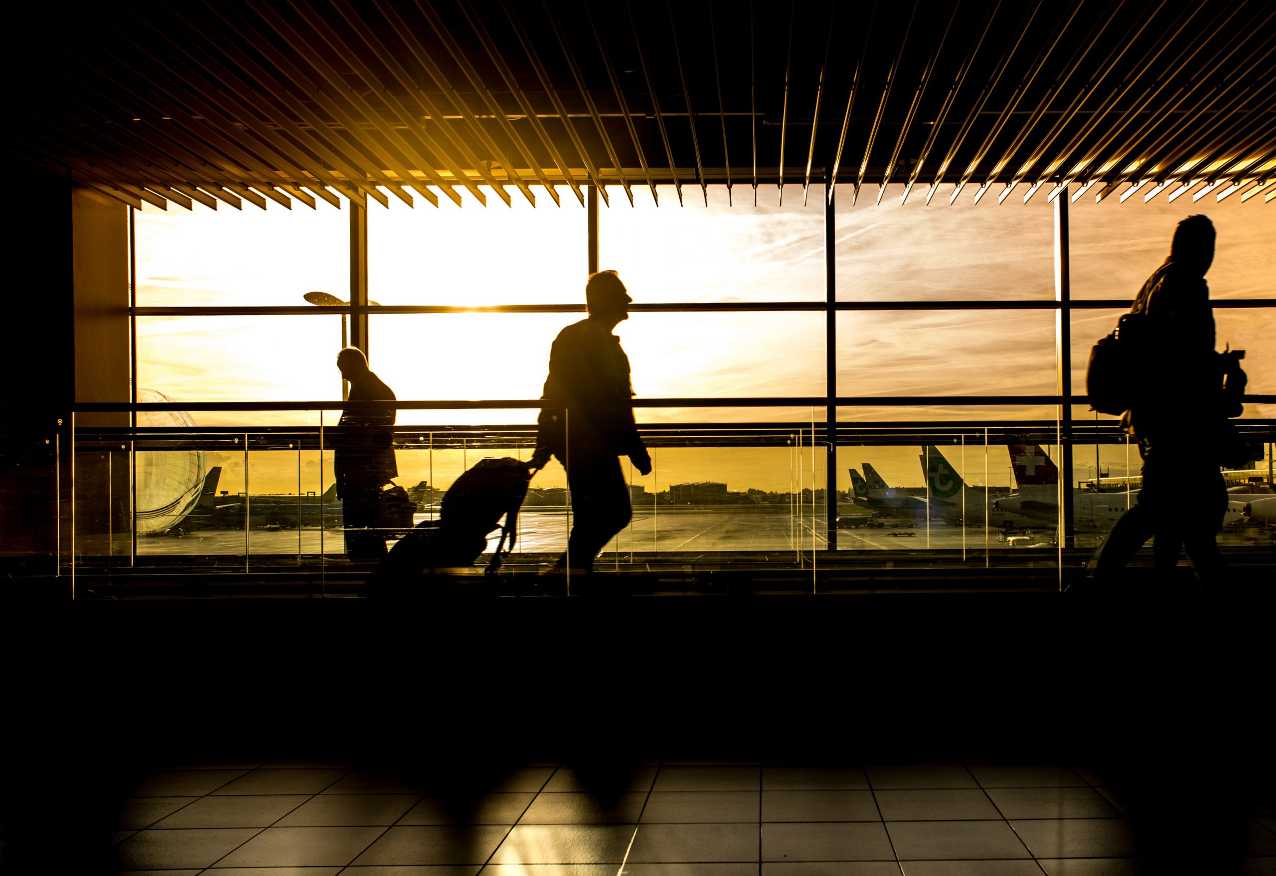 People walking through an airport - business travel safety tips