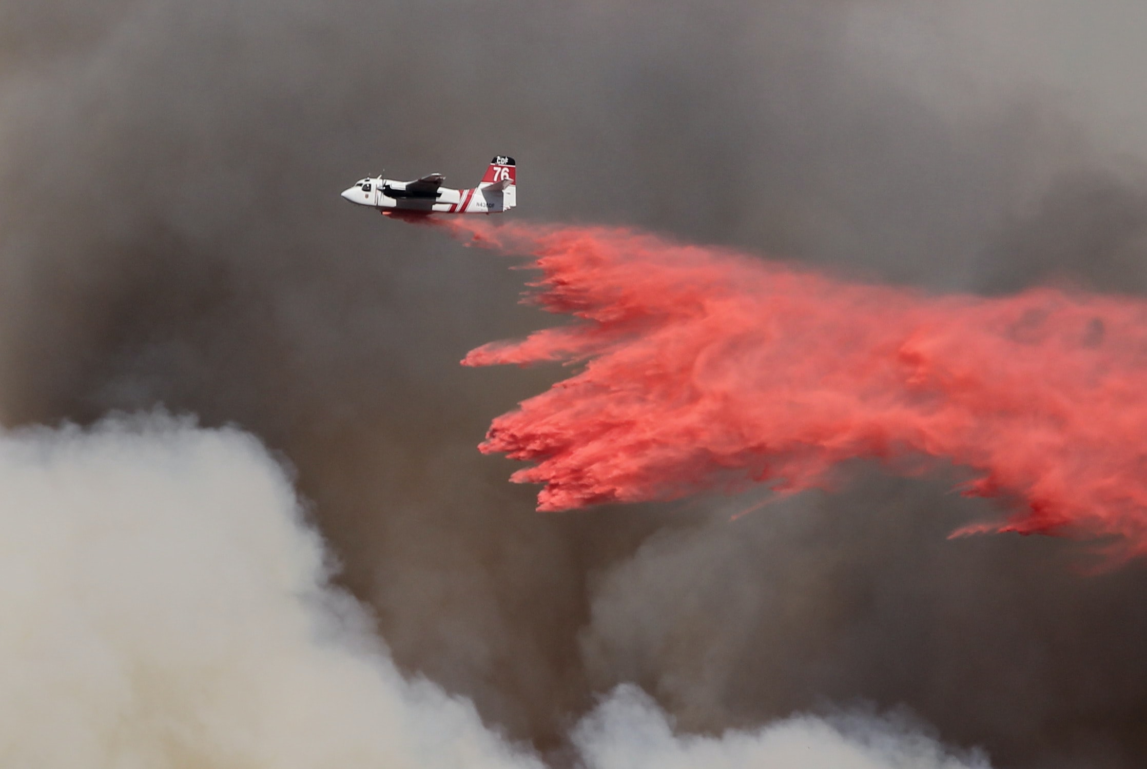wildfire plane dousing fires with chemicals